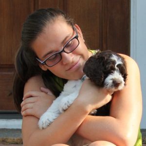 Maria says goodbye to a labradoodle ready for adoption.
